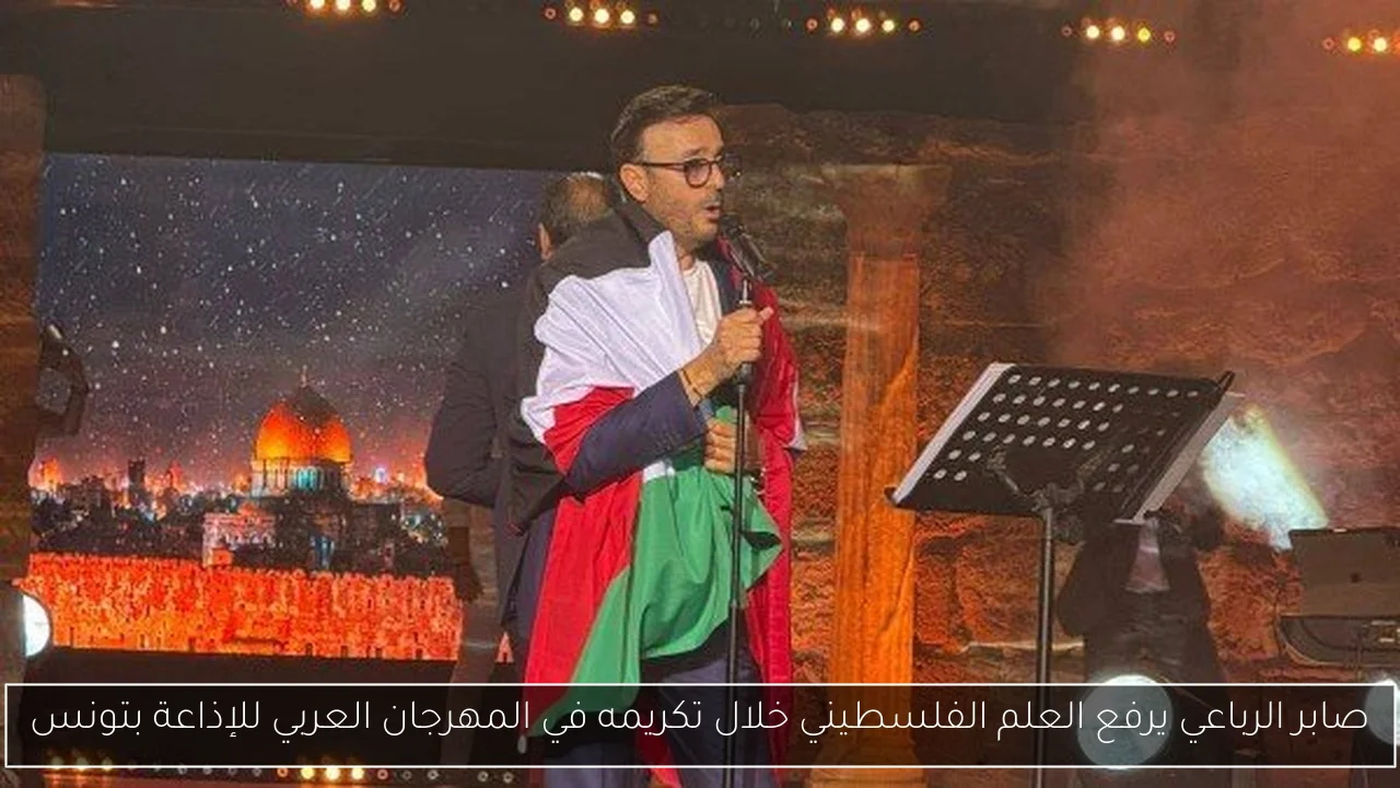 صابر الرباعي يرفع العلم الفلسطيني خلال تكريمه في المهرجان العربي للإذاعة بتونس